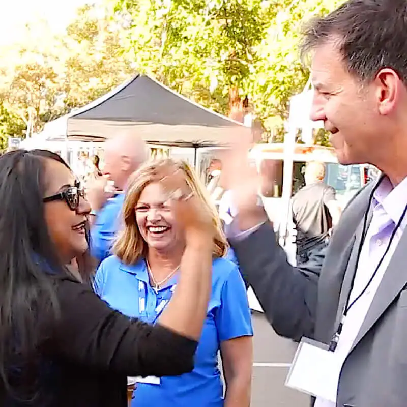 Doug high-fives an audience member.